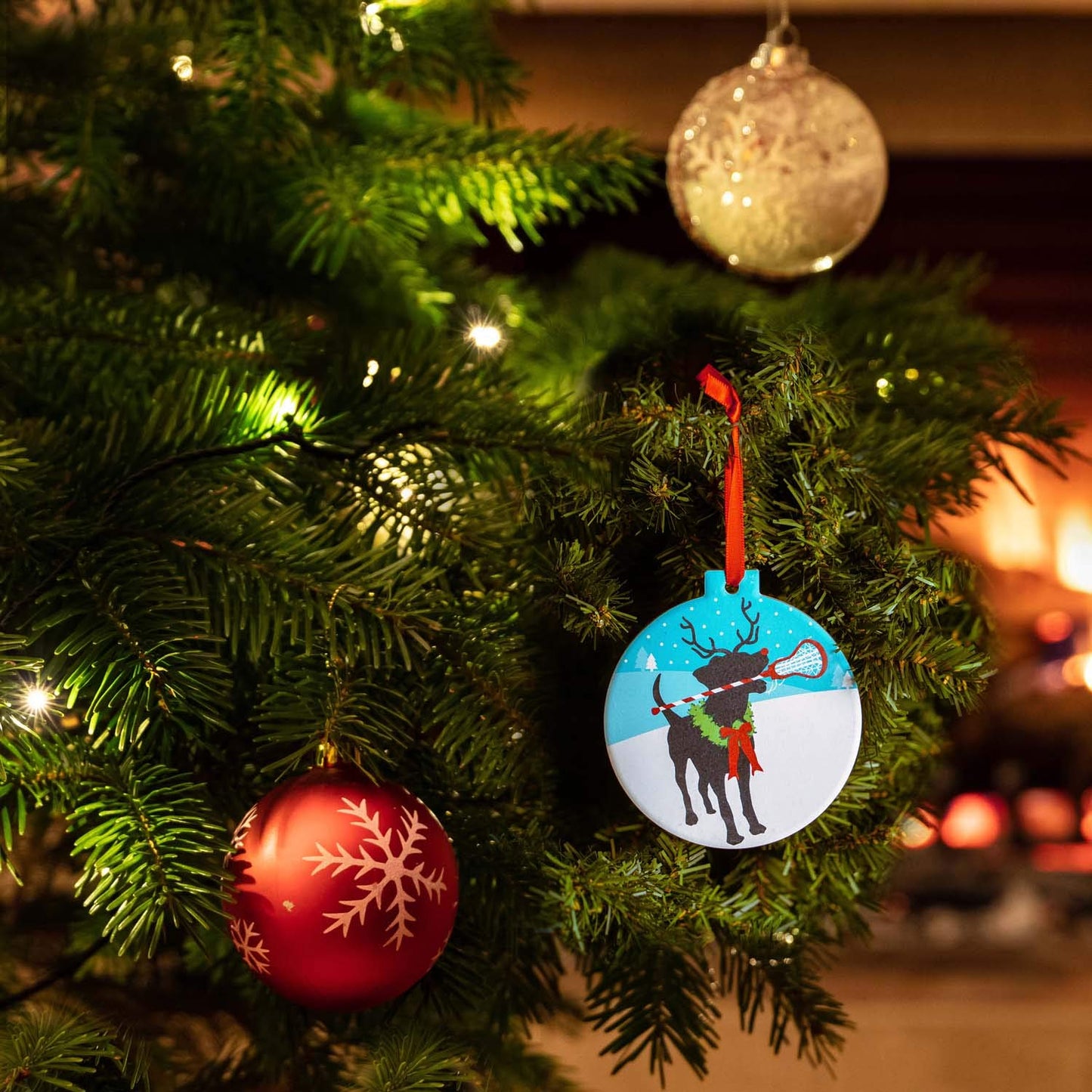 ChalkTalkSPORTS Girls Lacrosse Round Ceramic Ornament | Jingles The Lax Reindeer Dog