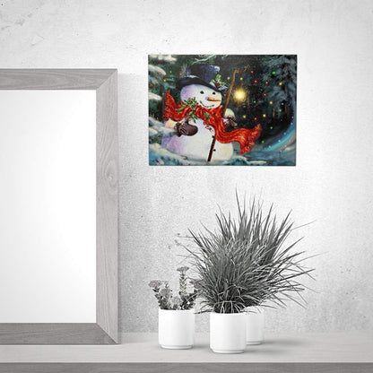 BANBERRY DESIGNS LED Wall Art - Lighted Snowman Canvas Print - Christmas Wall Hanging Snowman with a Red Scarf Holding a Lantern - Winter Holiday Scene 11.75" H x 15.75" W