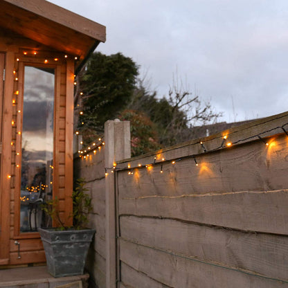 Festive Lights - 10m Solar Power Multi Function Fairy String Lights with 100 Warm White LEDs - IP44 Rated, Outdoor Decorative Lighting - External Panel, Black Cable, Garden Trees, Fences & Pergolas