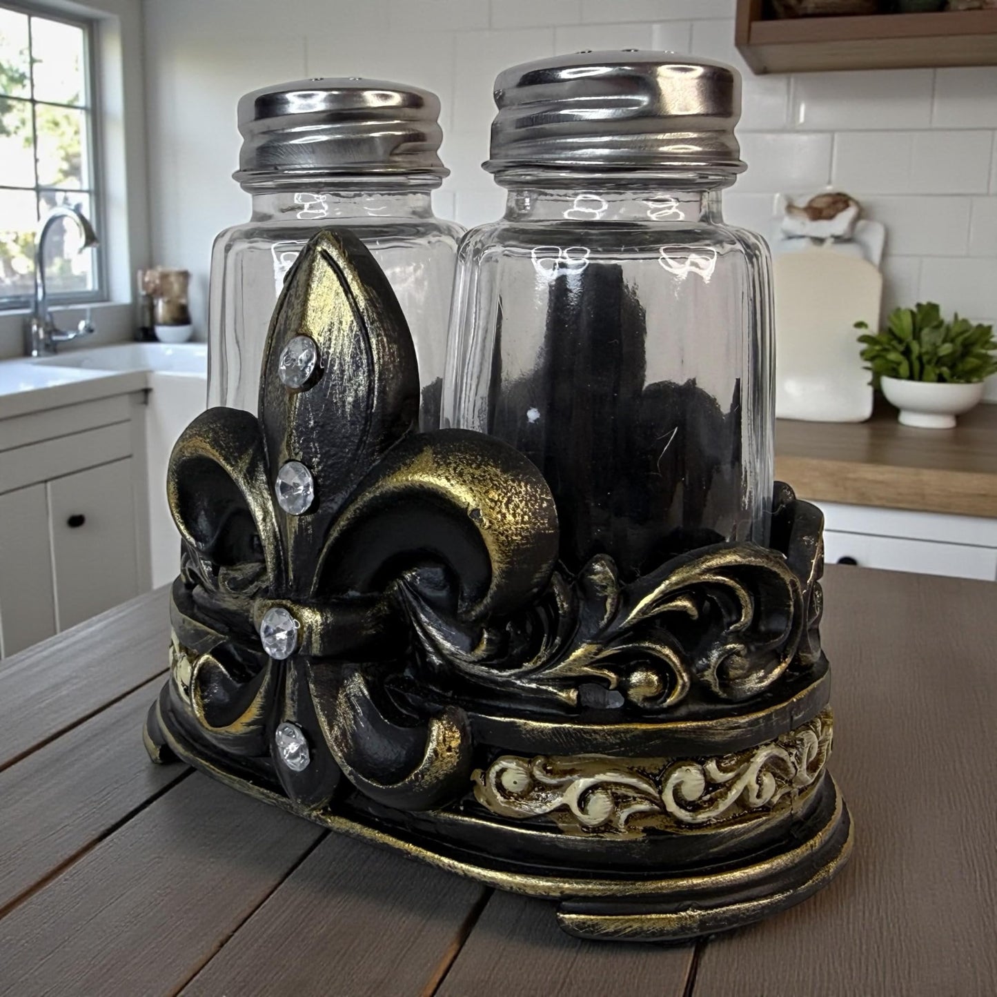 Fleur De Lis Salt and Pepper Shaker Set with Decorative Resin Holder – Glass Shakers with Stainless Steel Lids – French Country Cajun Kitchen Decor – 3 3/4” Tall Tabletop Seasoning Set