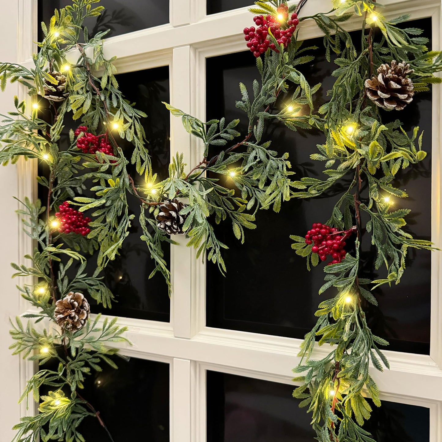 MINDELF 6 FT Artificial Christmas Garland, Faux Cypress Leaf Evergreen Garland with 20 LED Lights, Red Berries and Pinecones, Green-Yellow Leaves, Timer, Perfect for Indoor Outdoor Window Mantel